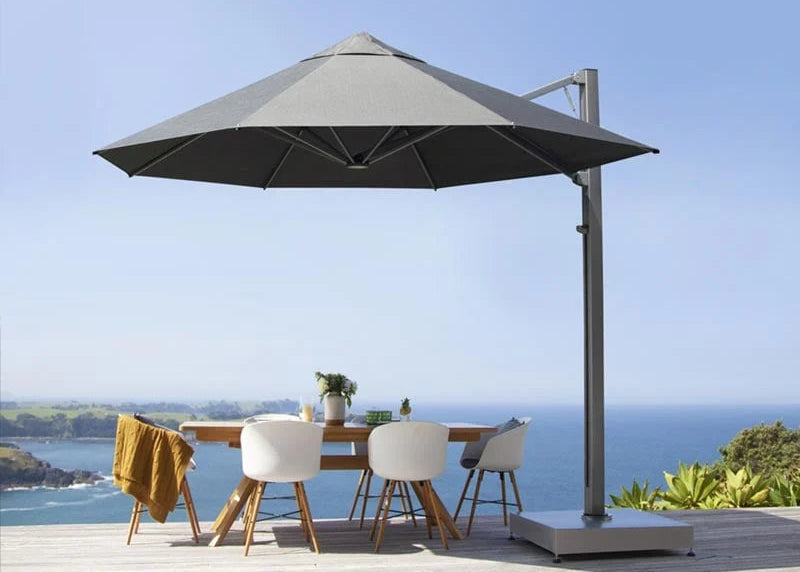 Large cantilever umbrella on a deck against a clear coastal outlook