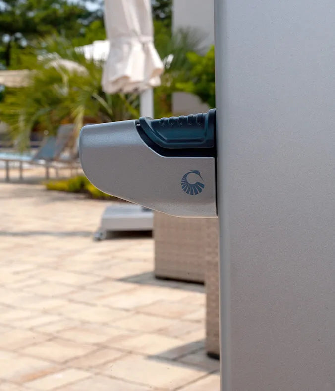 Close-up of an umbrella lifting mechanism with a logo in an outdoor setting,.