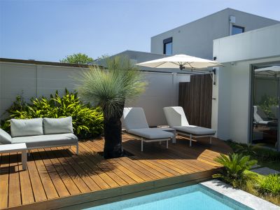 wall mounted umbrella by the pool